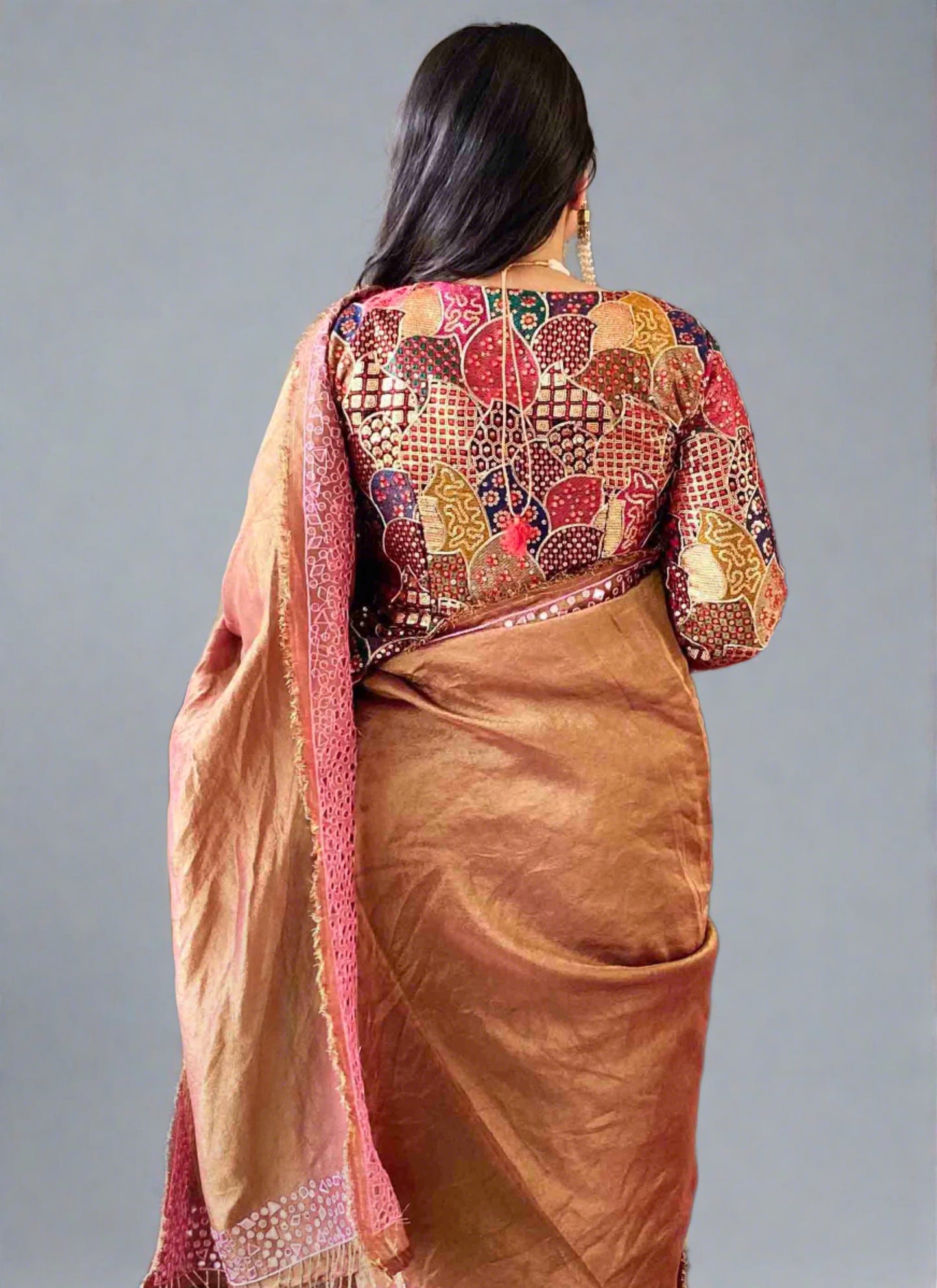 A woman wearing Brown Mirror Work Saree