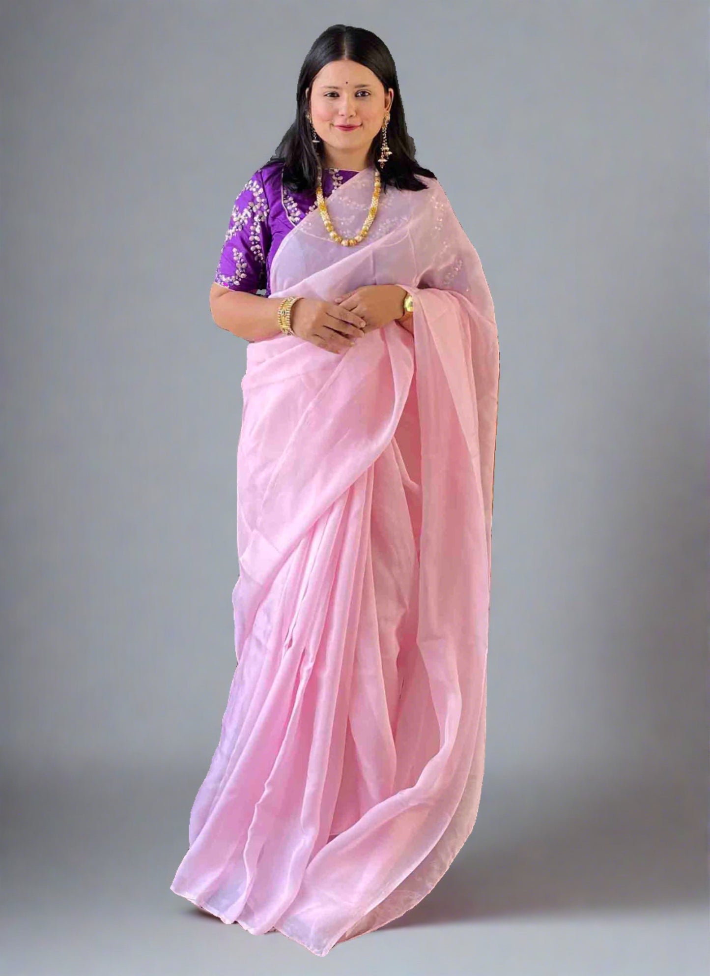 A woman wearing Pink Plain Saree