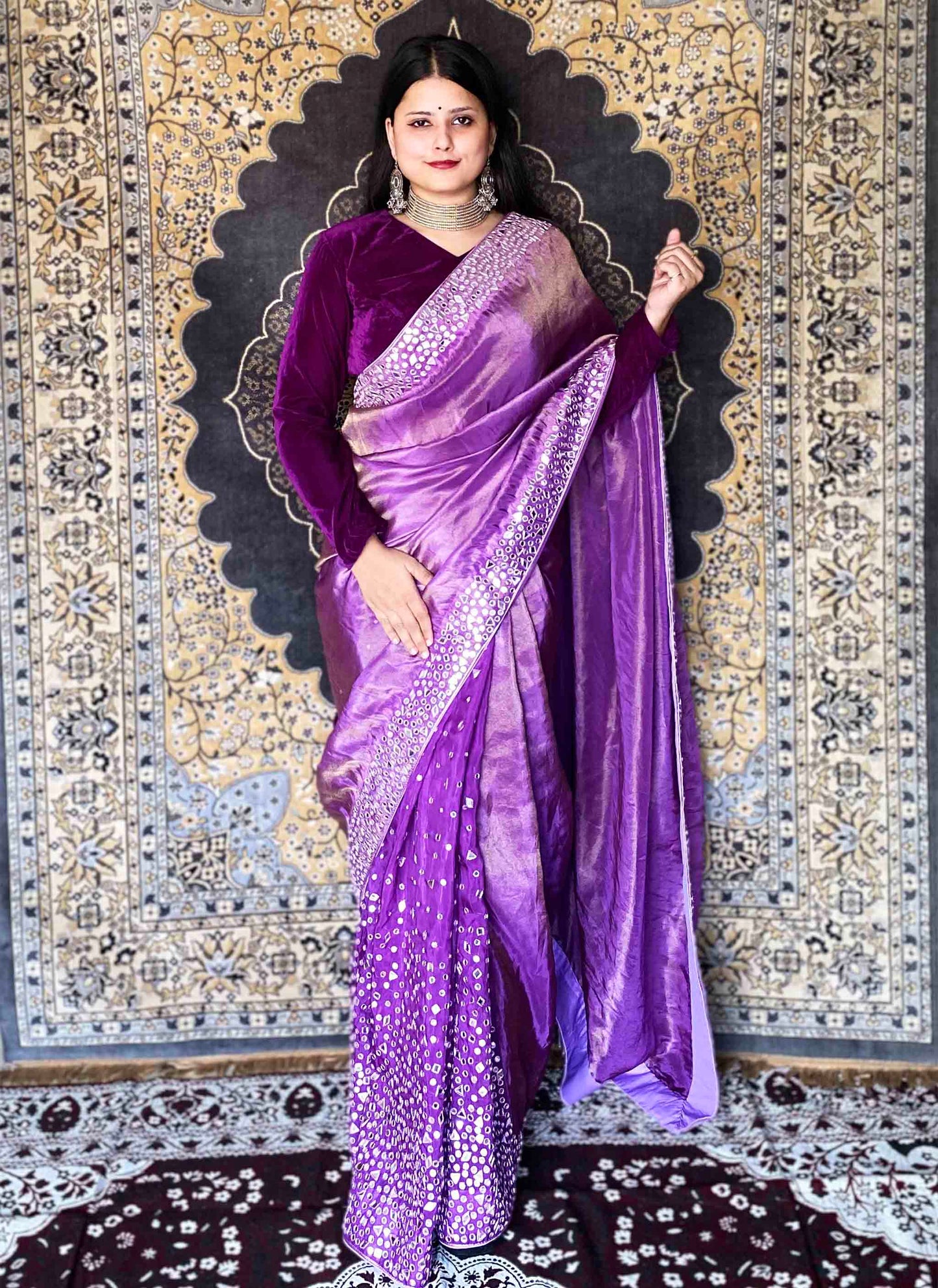 A woman wearing Purple Handwork Saree