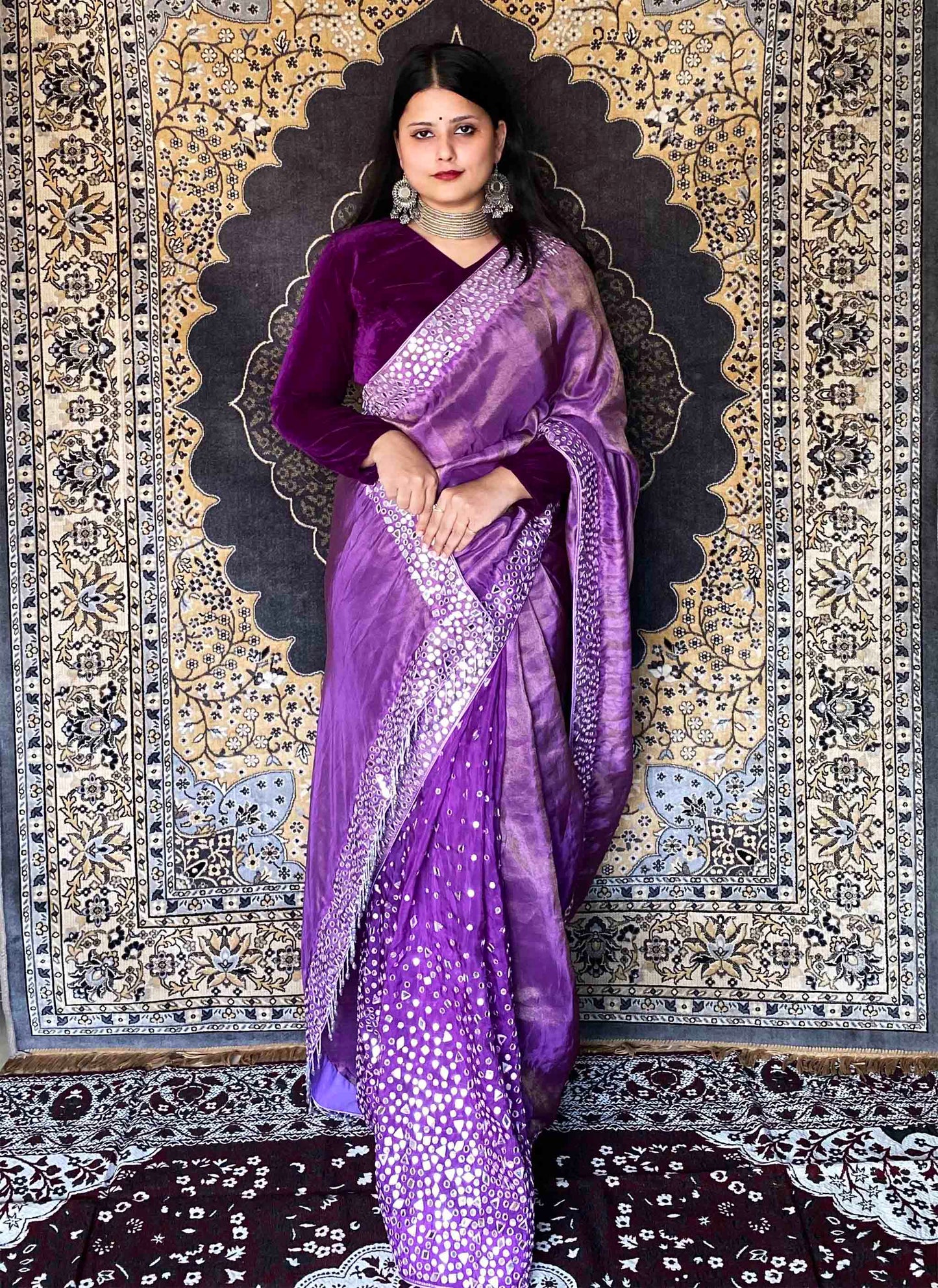 A woman wearing Purple Handwork Saree