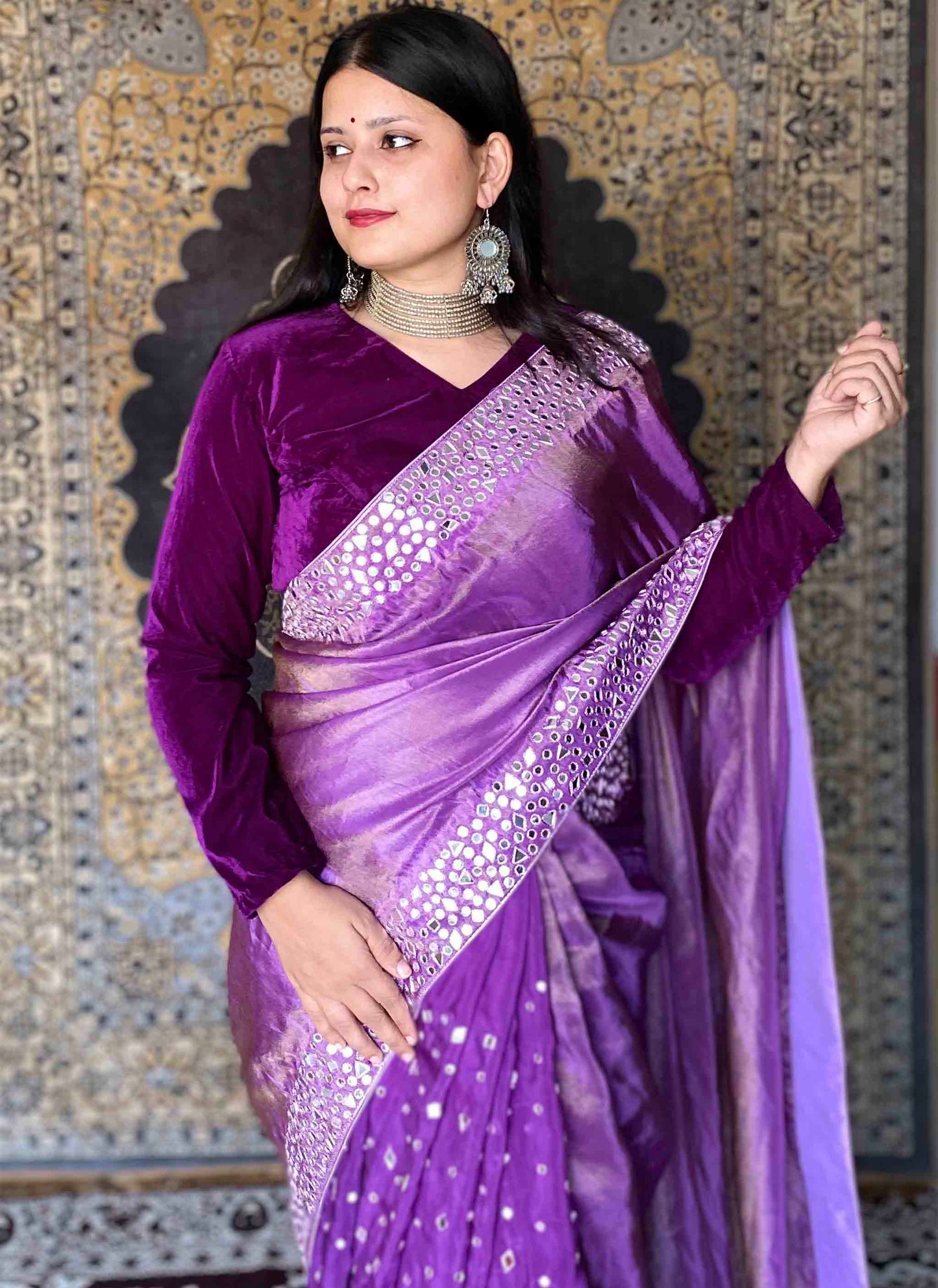 A woman wearing Purple Handwork Saree