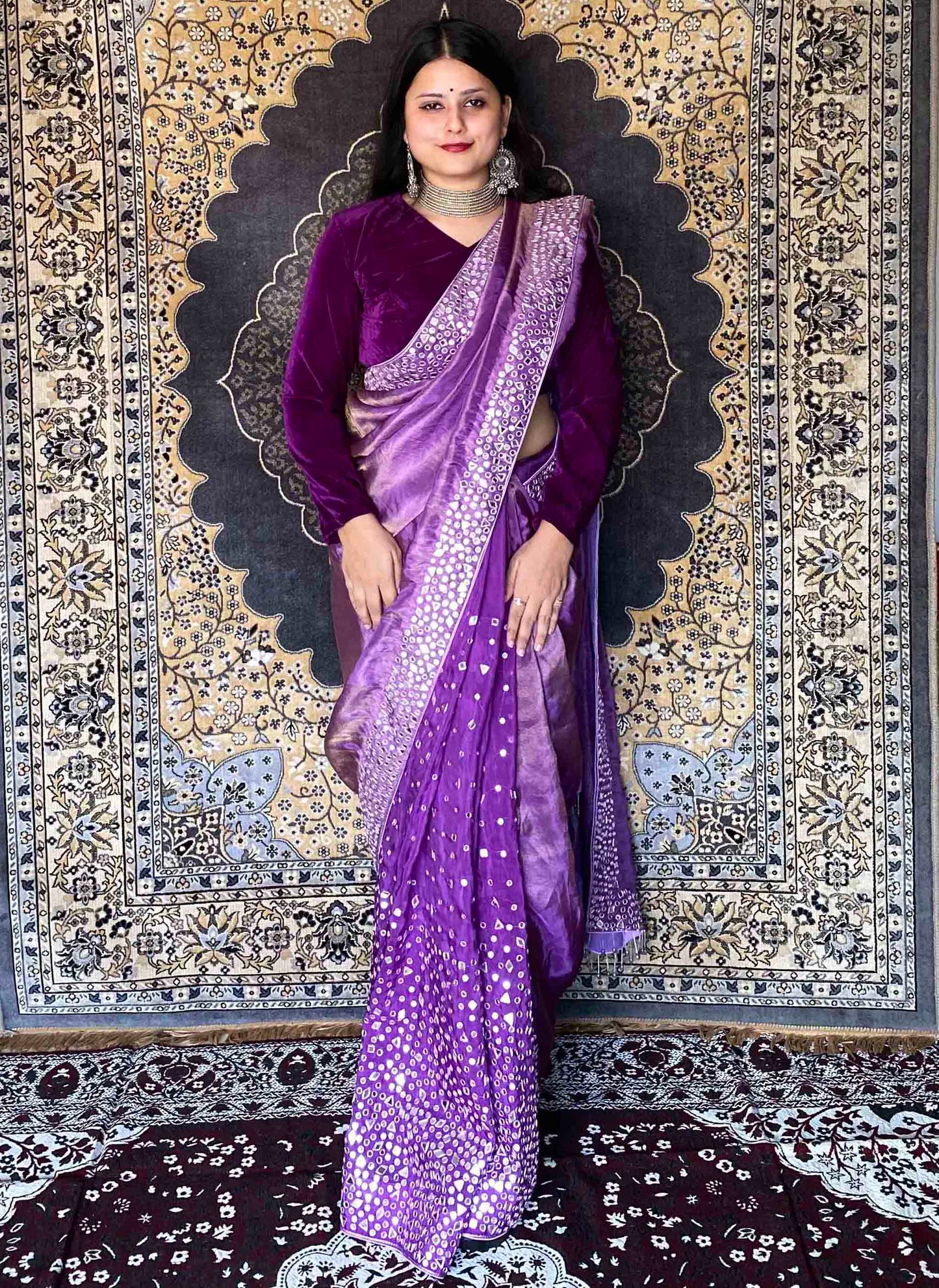 A woman wearing Purple Handwork Saree