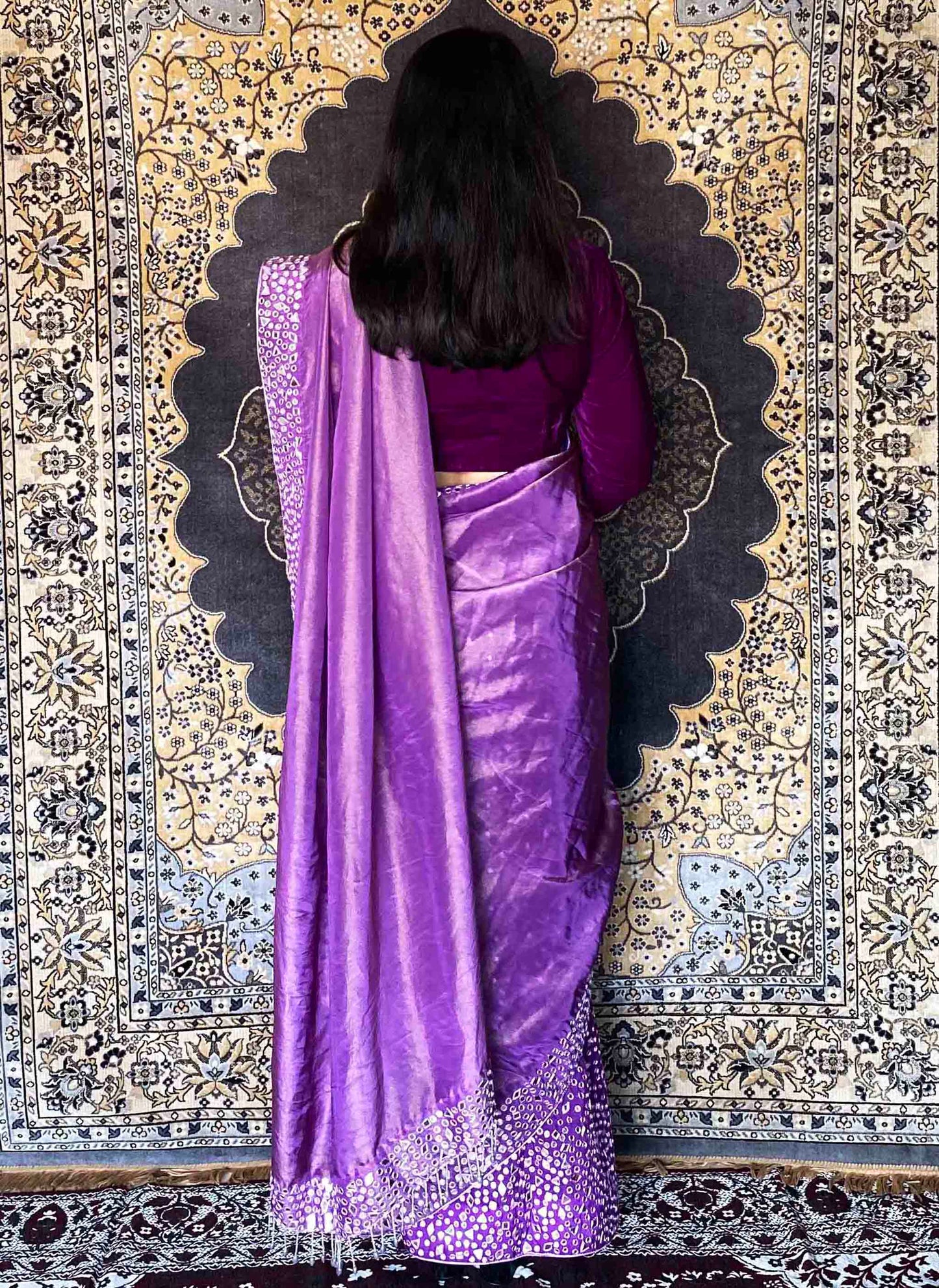 A woman wearing Purple Handwork Saree