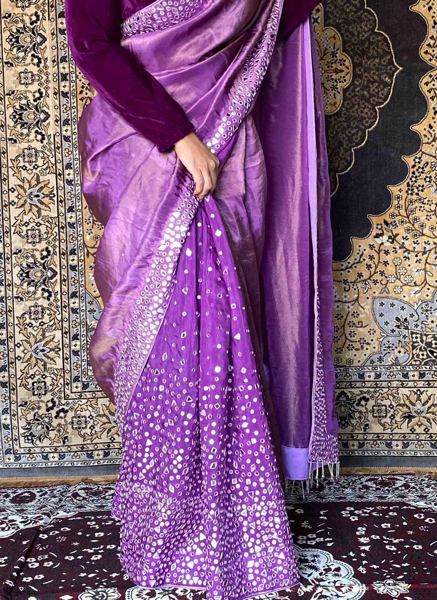 A woman wearing Purple Handwork Saree