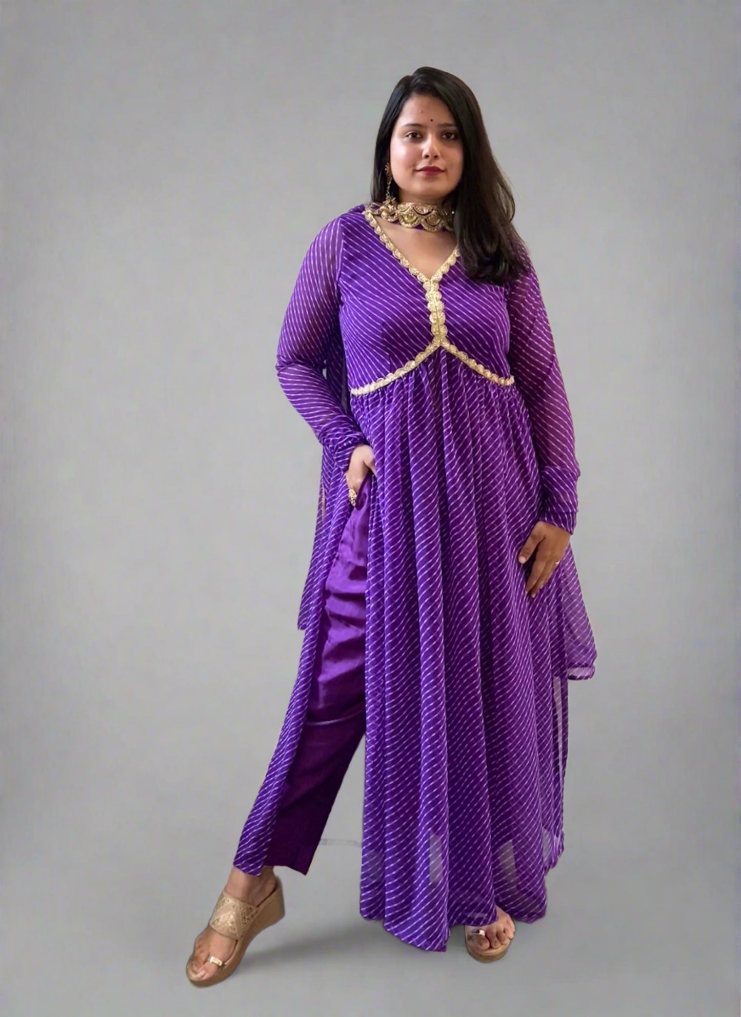 A woman wearing Purple Leheriya Kurta Set