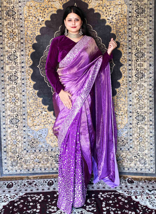 A woman wearing Purple Handwork Saree