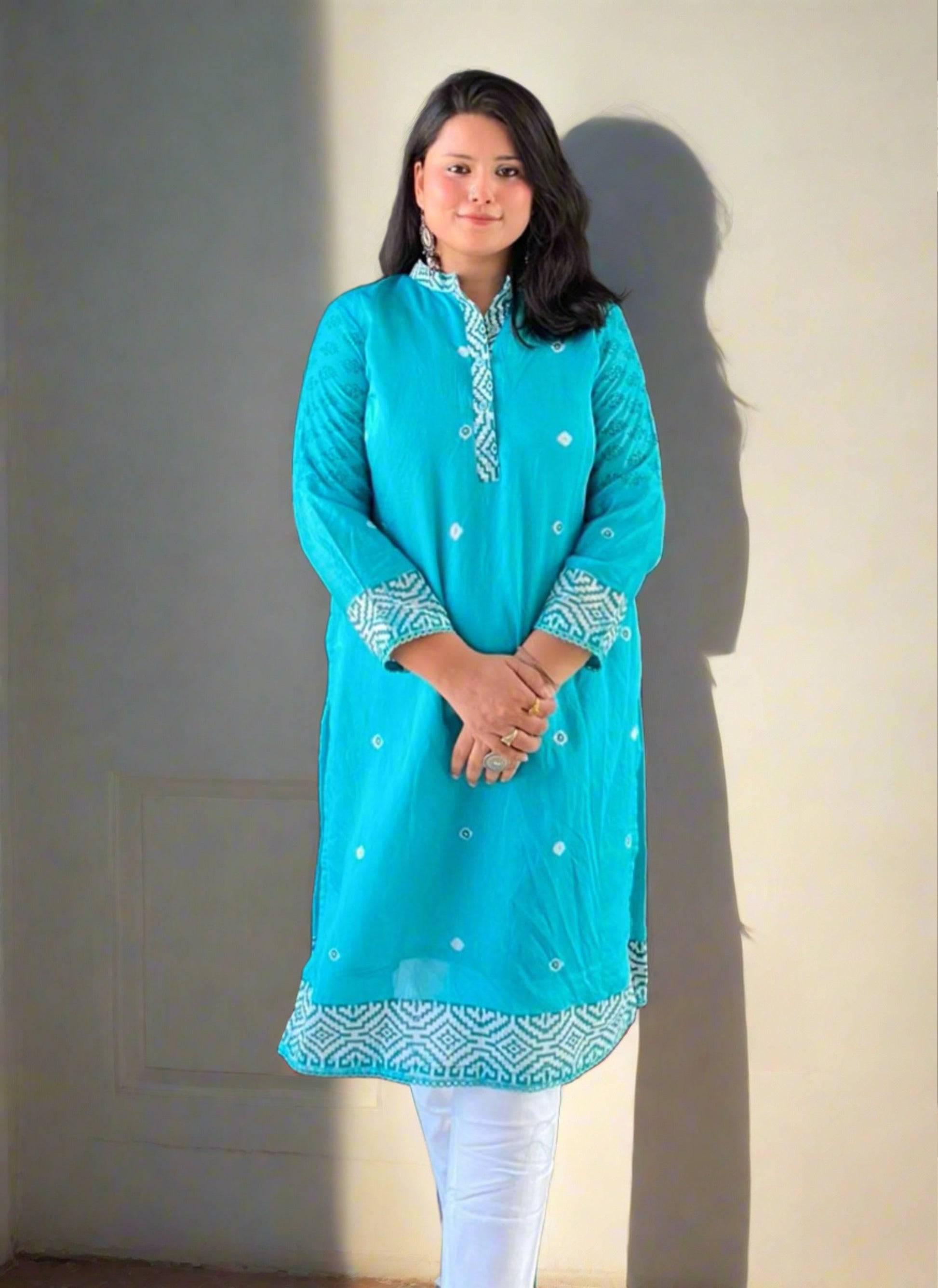 A woman wearing Turquoise Printed Mul Cotton Kurti